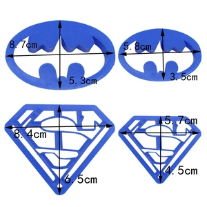 Blue Batman and Superman cookie cutter set with precise dimensions on white background