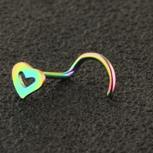 Macro shot of rainbow plated heart nose stud with hollow design on black background