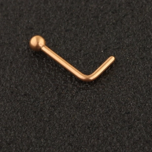 Macro shot of rose gold L-shaped nose stud with a polished round ball top ornament