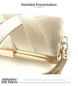 Macro detail of champagne satin evening clutch with woven texture and gold tassel