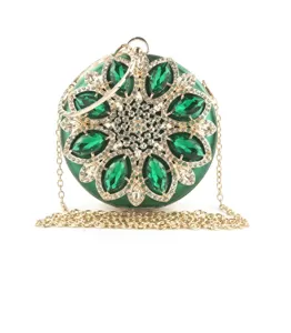 Detail of round luxury evening clutch with green marquise crystals and gold chain strap