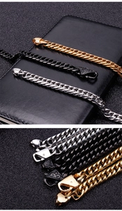 Detail of gold, black, and silver stainless steel Cuban link chains with lobster clasps
