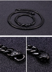 Detail of black stainless steel necklace and bracelet set with unique decorative clasps