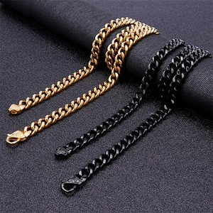 Mens fashion Cuban link chain necklaces in gold and black finishes on dark background