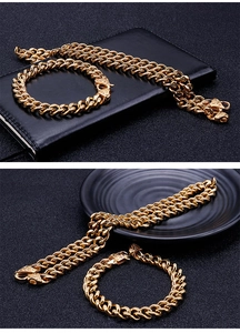 Detailed view of golden Cuban link necklace and bracelet set with engraved clasps