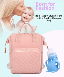 Macro detail of pink quilted nylon diaper bag featuring spacious front pockets and dual handles