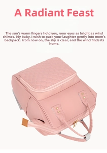 Detailed view of pink nylon quilted diaper bag with waterproof fabric and side pockets