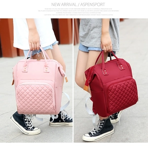 Quilted nylon diaper backpacks in pink and burgundy with water-resistant fabric