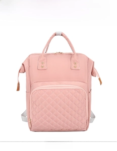 Detailed front view of pink nylon mommy bag featuring diamond quilted pocket and handles