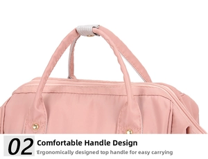 Pink nylon diaper bag featuring comfortable dual top handles with golden metal rivets