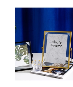 Close-up of 5x7 inch gold and black geometric metal photo frames with a crystal crown decor
