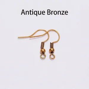 Close-up of antique bronze gold earring hooks with spring and ball DIY jewelry parts
