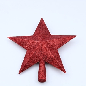 Macro detail of a red glitter star topper for a Christmas tree decoration with sparkly texture