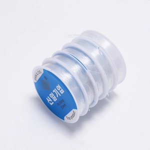 Detail of four 0.8mm clear elastic bead cords for jewelry making and DIY projects
