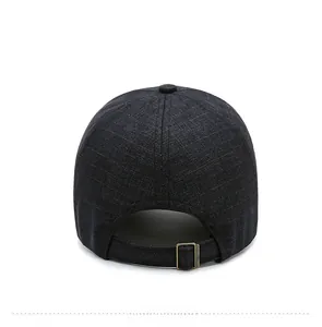 Detail view of the back of a casual baseball cap with a textured fabric and metal buckle