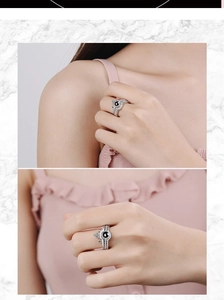 Detail of silver crown projection ring for couples featuring a black center stone inlay