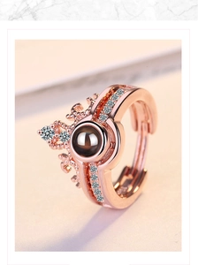 Detail of rose gold crown ring with projection stone and zircon stones on 45-degree angle
