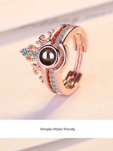 Detail of rose gold crown ring with 100 languages projection stone and crystal accents