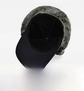 Detail view of winter trapper hat with thick black fleece lining and grey faux fur trim