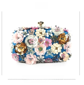 Detailed front view of a blue evening bag with 3D handmade sequin floral beadwork