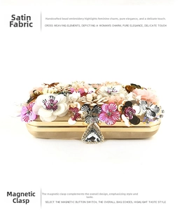 Detail of handmade fabric flowers and crystal heart clasp on a gold satin evening bag