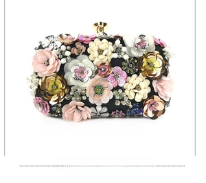 Detailed shot of handmade 3D floral beadwork and sequins on a black luxury evening clutch