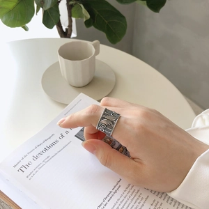 Vintage 925 sterling silver angel wing wide open ring for women on a book background