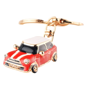 Red mini car keychain with white roof, gold-plated ring and sparkling rhinestone headlights