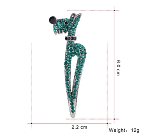 Detail view of a green rhinestone animal brooch with size dimensions 6.0cm by 2.2cm
