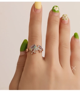 Detailed view of an adjustable unicorn ring with colorful enamel and zircon stones