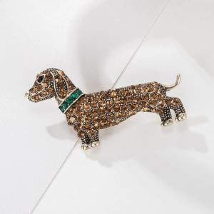 Vintage dachshund dog brooch in antique gold with brown crystals and green collar detail