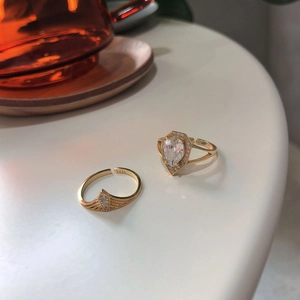 Detailed view of S925 silver rings with teardrop zircon and warm gold plating