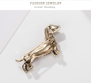 Detail view of the vintage dachshund brooch back featuring the secure pin clasp mechanism