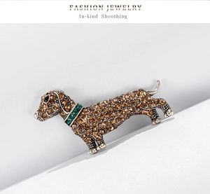 Detailed view of dachshund brooch featuring amber rhinestones and antique silver finish