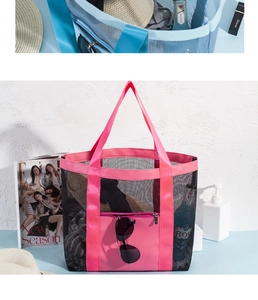 Detailed view of black mesh beach bag with pink straps and front zipper pocket