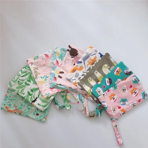 Detail view of cotton mini bags with diverse animal prints and secure zipper closure