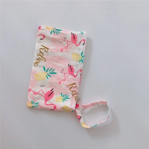 Detail of canvas pouch with pink flamingo, pineapple print and Relax text with wrist strap