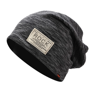 Detail of gray knitted beanie with vintage Rock patch and warm thick fabric texture