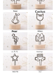 Close-up of assorted vintage wood base photo clips in flower and animal shapes