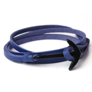 Macro detail of blue leather wrap bracelet with a black metal anchor-shaped buckle