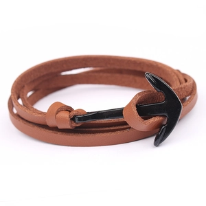 Detail view of multilayer brown leather wrap bracelet with black metal anchor hook clasp