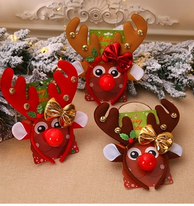 Close-up of three festive reindeer headbands with antlers and bells on a holiday background