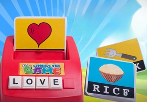 Close-up of spelling toy base with cards for love, rice, and fork for word learning