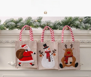 Detail of Christmas burlap gift bags featuring 3D Santa, Snowman and Reindeer embroidery