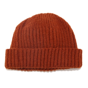 Detail of caramel ribbed knit beanie showing thick texture and warm woolen fibers