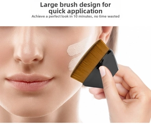 Detail of professional hexagonal makeup brush applying liquid foundation on smooth skin