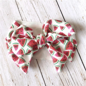 Detailed close-up of a wide fabric headband featuring a 3D large watermelon print bow