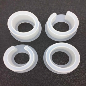 Detailed view of four white translucent silicone resin molds for DIY oval bangles