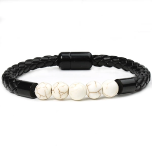 Close-up of black braided leather bracelet with five white turquoise stone beads and magnetic clasp