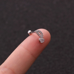 Macro detail of crescent moon stud earring with heart zircon on stainless steel post